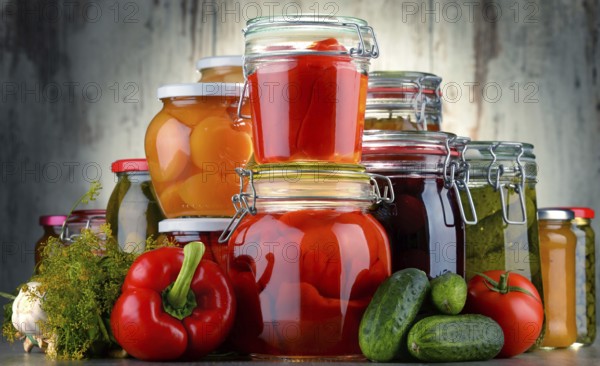 Jars with pickled vegetables and fruity compotes. Preserved food