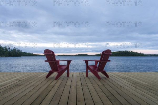Known as Muskoka or Adirondack chairs sit on a dock at a resort in Muskoka, Ontario, Canada, North