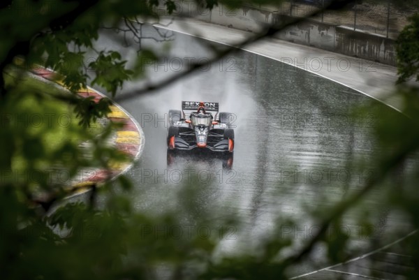 SANTINO FERRUCCI (14) of Woodbury, Connecticut comes through turn 12 (Canada Corner) during a wet