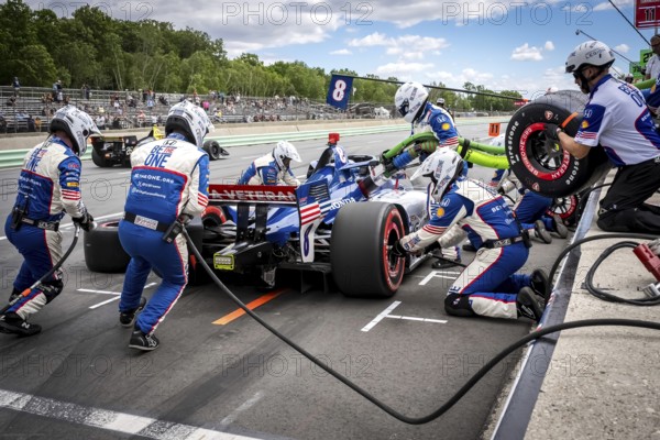LINUS LUNDQVIST (R) (8) of Stockholm, Sweden comes down pit road for service during the XPEL Grand