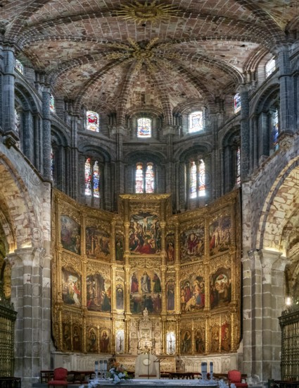 Avila, Spain, 8 April, 2024: view of the central nave and altar with gilded altar piece in the