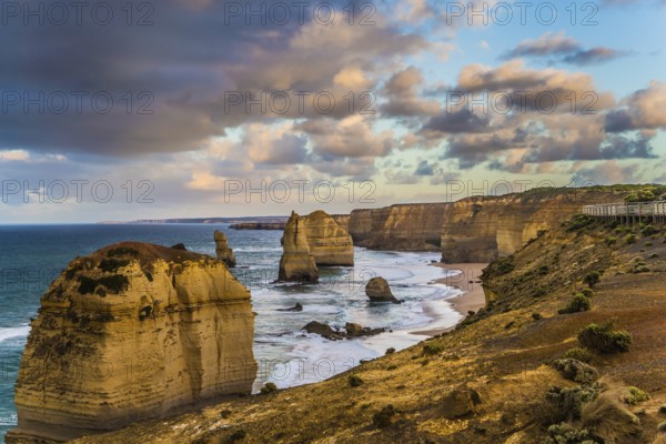 Travel to Australia. Pink dawn clouds over the rocks Twelve Apostles. Early morning on the ocean