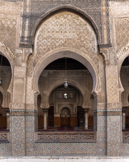 Fes, Morocco, April 05, 2023, Traditional oriental facade at the courtyard of madrasa Bou Inaniya