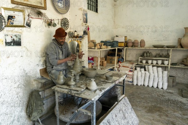 Fez, Morocco, 4 March, 2024: Moroccan potter at work in his pottery studio in downtown Fez northern