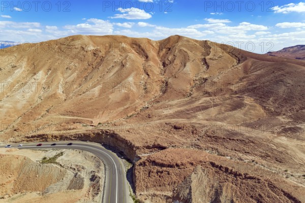 Judean desert on the shores of the Dead Sea. Dry waterless hills of yellow, beige and gray clay.