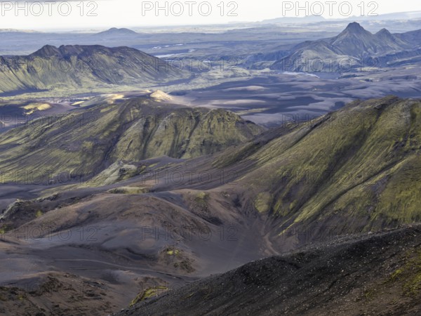 View from Mount Sveinstindur, volcanic landscape, moss-covered hills, mountains, Icelandic