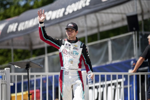 Chandler Smith walks across the stage during driver intros prior to the Road America 180 at Road