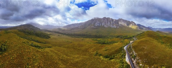An aerial view of Gordon River Rd at the Sentinel range of mountains near Bitumen Bones Sculpture