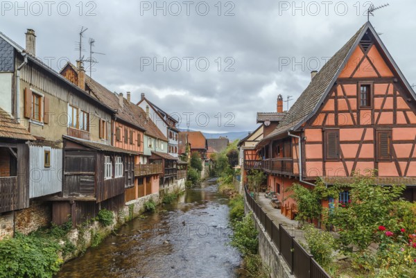 View of Weiss river with historical houses in Kaysersberg, Alsace, France