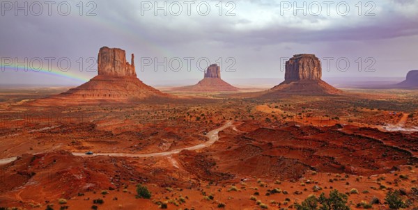 USA. Navajo Indian Reservations. The famous rock Mitten and the bright rainbow. Monument Valley is