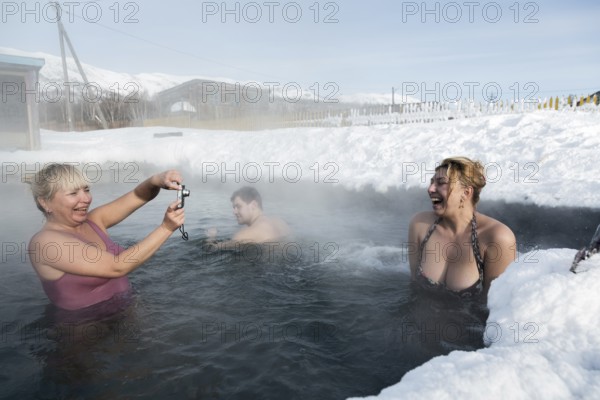 KAMCHATKA PENINSULA, RUSSIA, FEB 02, 2013: Two joyful women photographed while swimming in