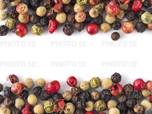 Mixed peppercorns background with white copy space in center. Food background with peppercorns.