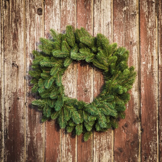 Christmas wreath on the shabby wooden door. Christmas holiday background with copy space