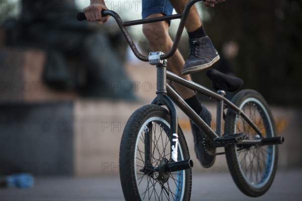 Young teenager bicyclist boy riding on beautiful orange bmx bicycle male hobby extreme sport male
