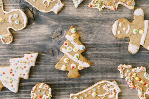 Colorful Christmas gingerbreads in the shape of Christmas trees and little men decorated with color