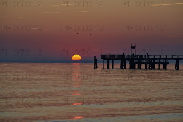 Sunrise over the sea at the pier of the Baltic Sea resort, Boltenhagen, Mecklenburg-Vorpommern,