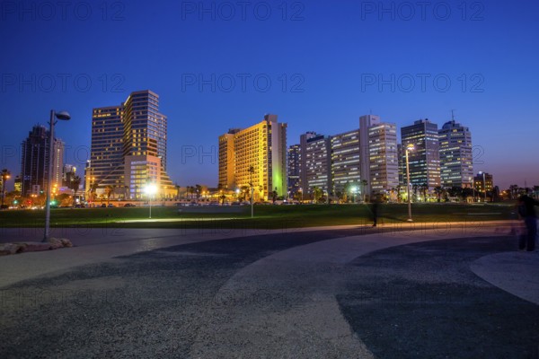 Amazing cityscape of Tel-Aviv, blurred people, luxury buildings- close to coastline ! Blue hour in