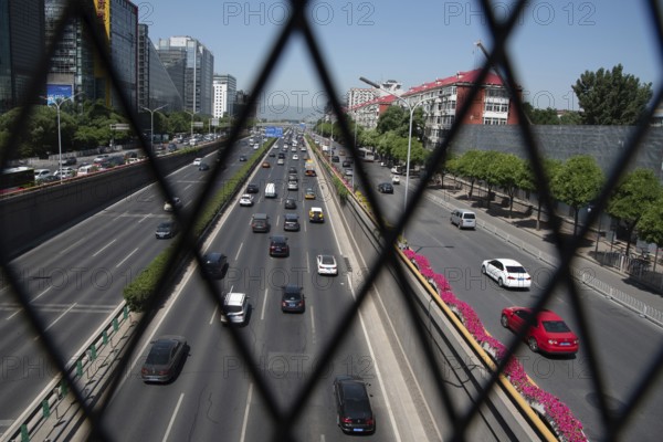 Beijing, China ? June 4 2019: Cars moving fast on a busy multi lane highway in city of Beijing in