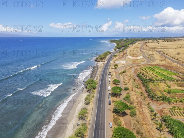 Aerial view of beach and ocean with waves in the island of Maui, Hawaii. Launiupoko State Beach