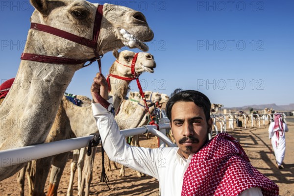 Sheikh with his racing camel at the Al Ula Camel Cup in the Mughayra Heritage Sports Village, Al