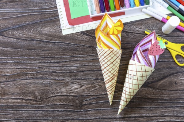 Paper Fan paper ice cream on a wooden table. Childrens art summer project, handmade, crafts for