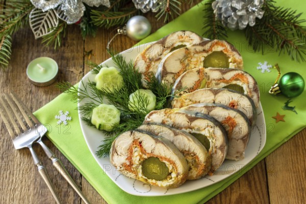 Festive snack. Baked mackerel roll stuffed with cheese, carrots, eggs and pickled cucumber, served