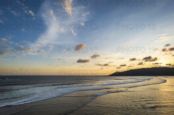 Beautiful sunset landscape at tropical beach in Lombok, Indonesia. Bright sunset landscape near
