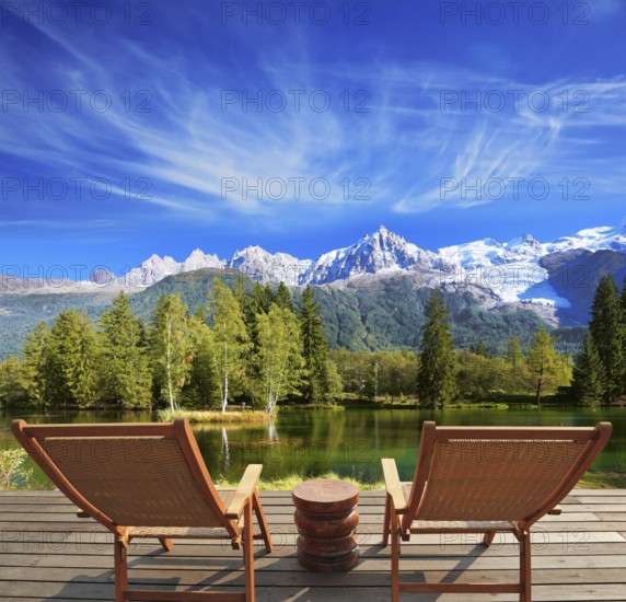 City park in the Alpine resort. Comfortable lounge chairs on wooden platform for rest and