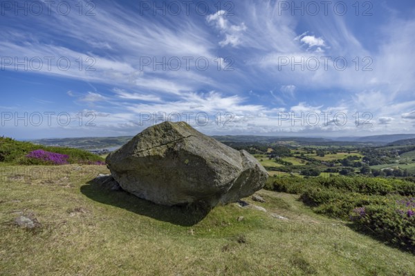 Large rock on a hill with sweeping views over a green landscape around Conwy and Conwy Castle on