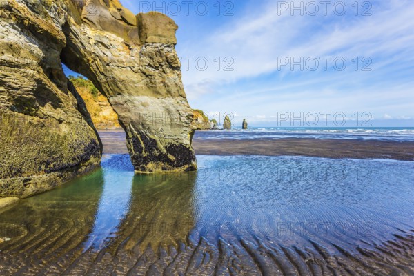 Coastal rock arches Three Sisters and Elephant on the Pacific coast. The concept of active and