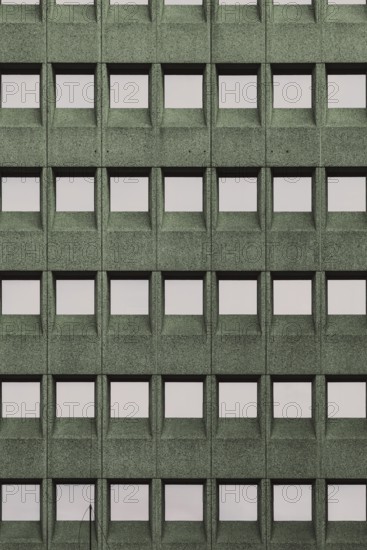 Building facade with a green grid pattern and square windows, in Rotterdam, South Holland,