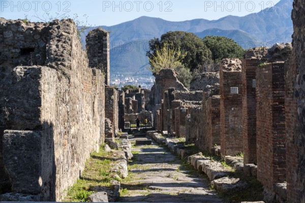 POMPEII, ITALY, MAY 04, 2022, A beautiful typical cobbled street in the ancient city of Pompeii,