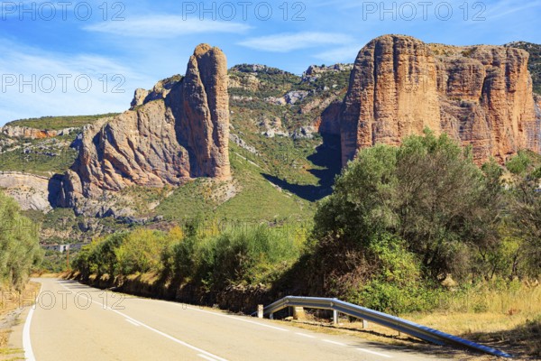 Asphalt highway passes through the rocks. Part of the foothills of the Pyrenees. The Mallets of