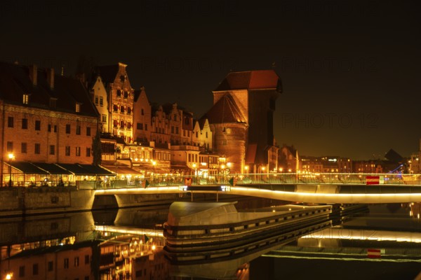 Old town in Gdansk at night. The riverside on Granary Island reflection in Moltawa River Cityscape