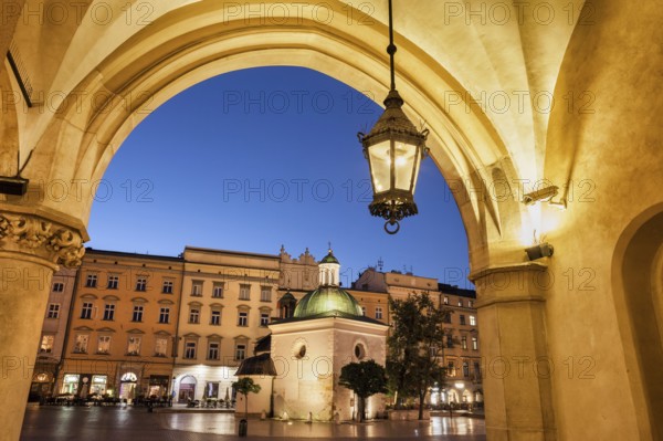 City of Krakow by night in Poland, Ranaissance arch of the Cloth Hall (Sukiennice), St. Adalbert