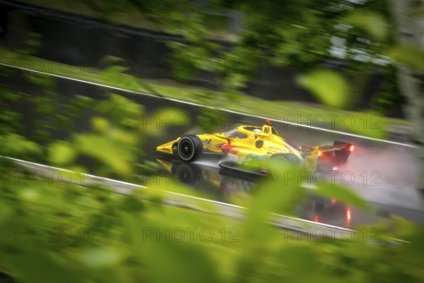 ALEX PALOU (10) of Barcelona, Spain comes through turn 12 (Canada Corner) during a wet practice