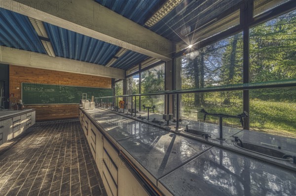 Sunlit, abandoned laboratory with old lab benches and a view of the countryside, Institute of