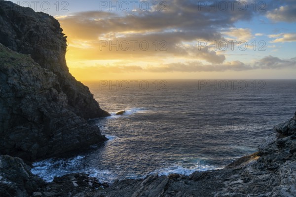 Long exposure sunset seascape with rocks and reef at Capo Falcone in Sardinia