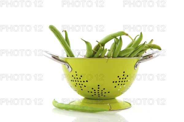 Green colander and French beans to wash and prepare