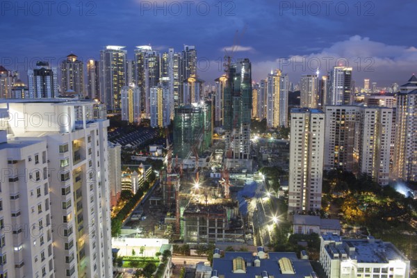Construction works in residential area of Kuala Lumpur with high-rise apartment blocks. City