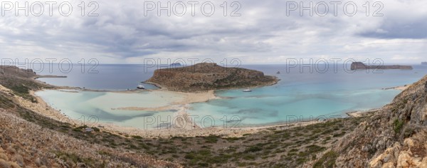 A panorama picture of the blue water of Balos Beach and the nearby landscape of the Gramvousa