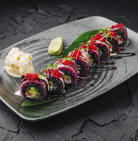 Food, Vibrant sushi rolls are arranged beautifully on a dark plate, showcasing various colors and
