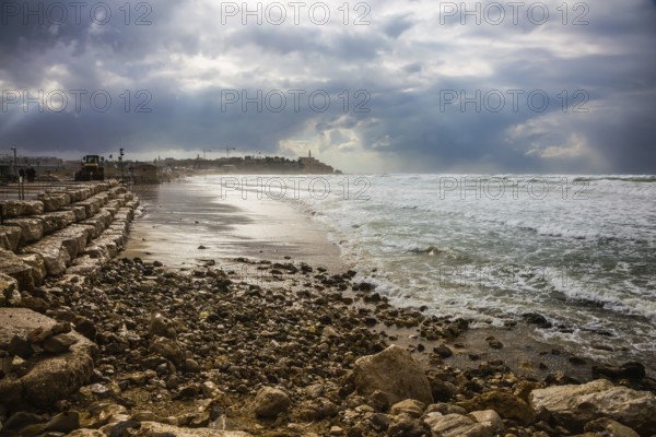 The storm in the Mediterranean Sea. Huge foaming waves beating against the shore. New Quay in the