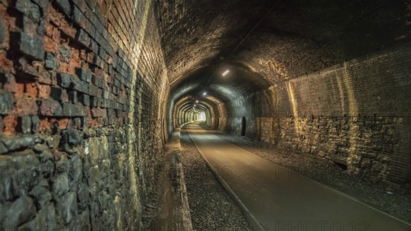 Walking through the Headstone Tunnel, near Monsal Head in the East Midlands, Derbyshire, Peak