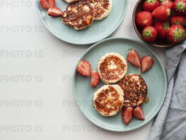 Sweet cheese pancakes on plate served strawberries. Cottage cheese pancakes, syrniki, ricotta
