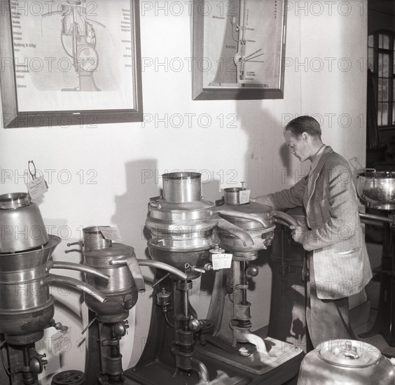 History of milk and cream making machinery. A man in a museum of separators. Machines made for the