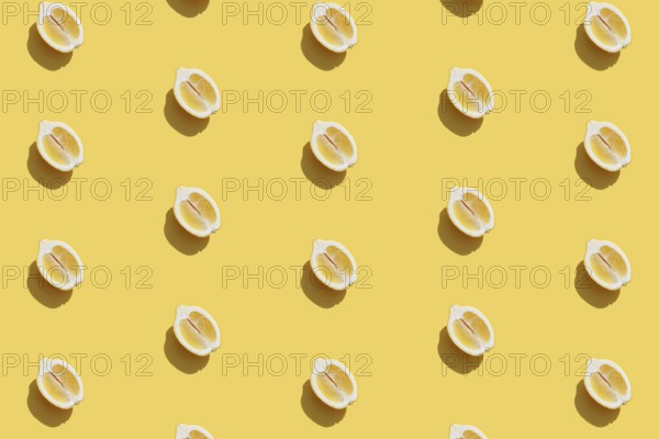 Conceptual pattern with halves of lemon collection with shadow on yellow background. Healthy