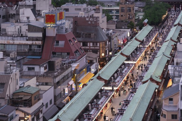 Tourists walk through the Nakamise-dori shopping street of Senso-ji in Asakusa. Senso-ji is the