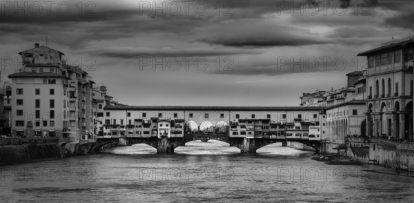 Beautiful black and white photo of the Ponte Vecchio, a medieval stone arch bridge over the Arno