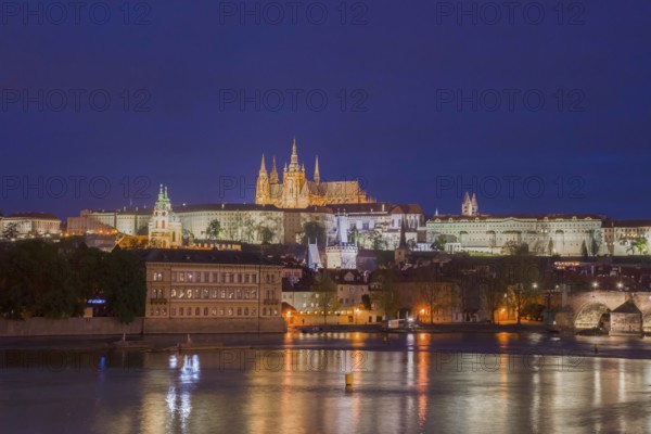 Vltava river with famous Hradcany castle and St. Vitus Cathedral in Prague, Czech Republic, by